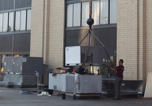 Technician installing commercial HVAC in Illinois