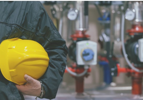 Mechanic Holding Yellow Hard Hat After a Commercial Boiler Inspection in Illinois